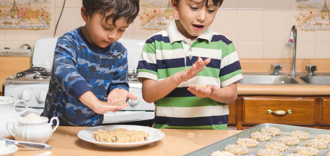 two kids making cookies