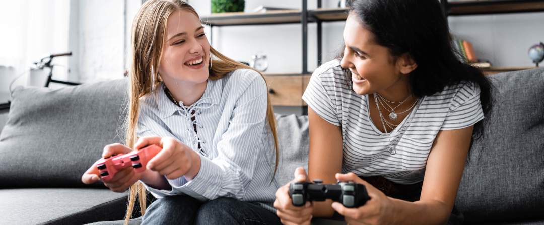 Two girls laughing and playing games