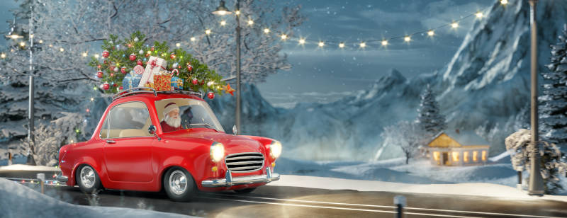 Santa claus in Cute little retro car with decorated christmas tree on top goes by wonderful countryside road.